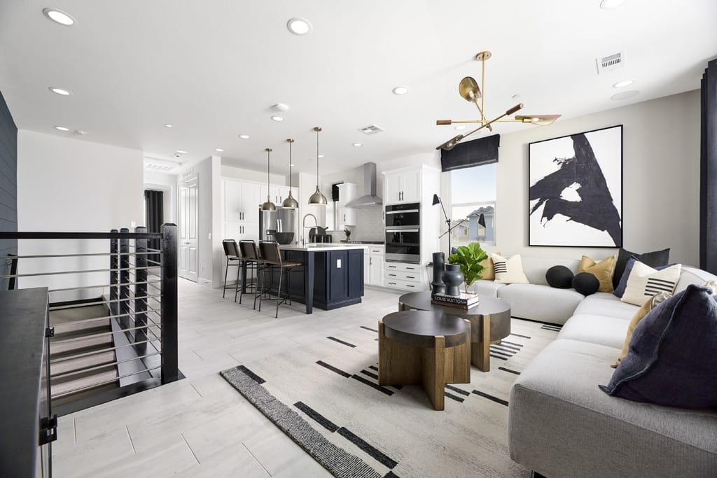 Open-rail staircase leads up to second-story great room and open kitchen-dining area