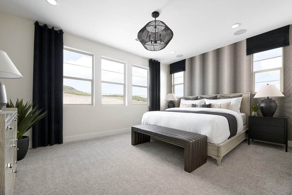 Primary bedroom lined with windows along two walls